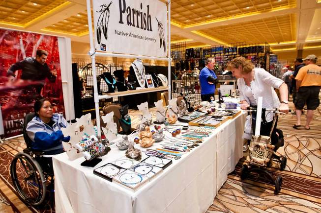 Shauna Roberts, right, admires the Native American jewelry on sale as Drusilla Parish mans her booth at the Official Star Trek Convention at the Rio in Las Vegas on Saturday, Aug. 10, 2013.